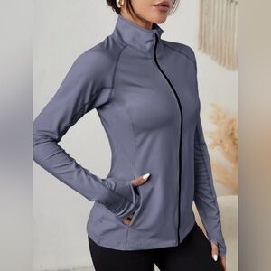 Brand new with tags zip up slant pocket warming sports jacket with thumb holes.